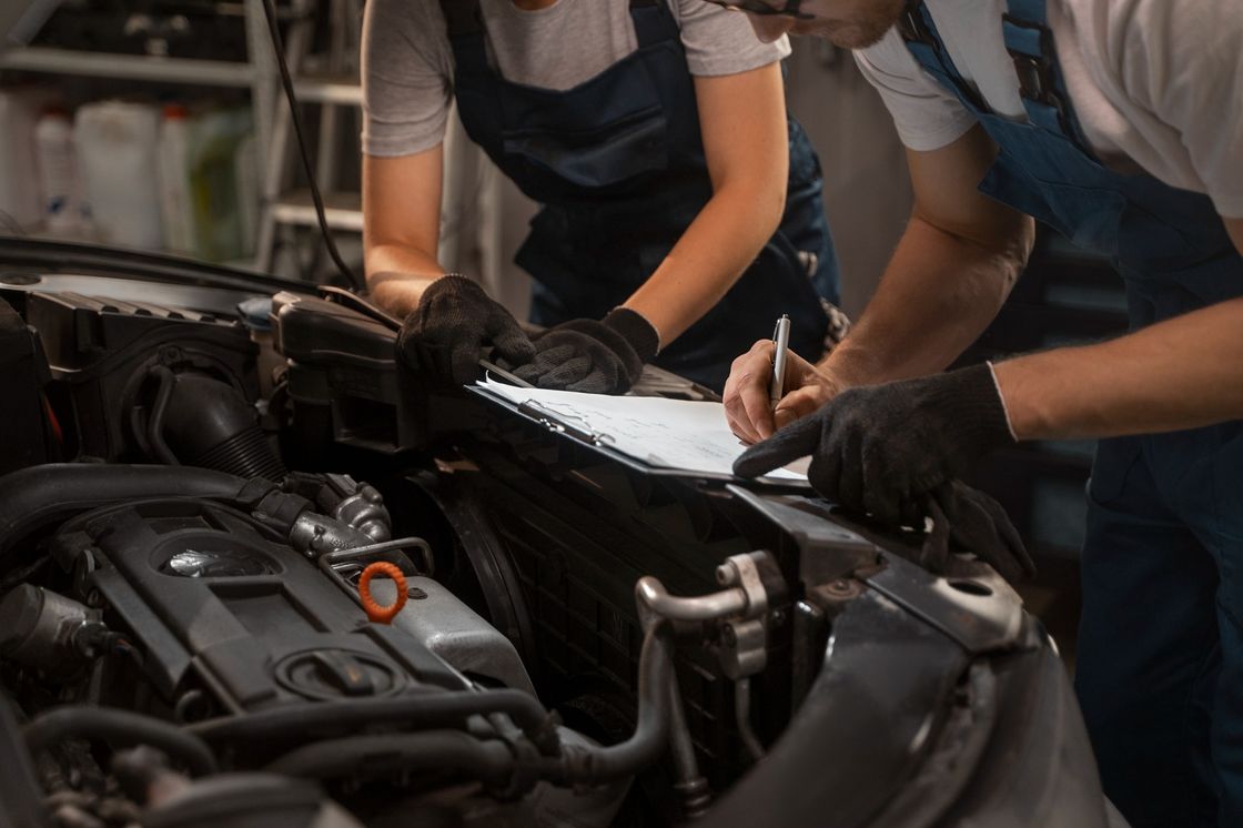 Technicians working on a car engine